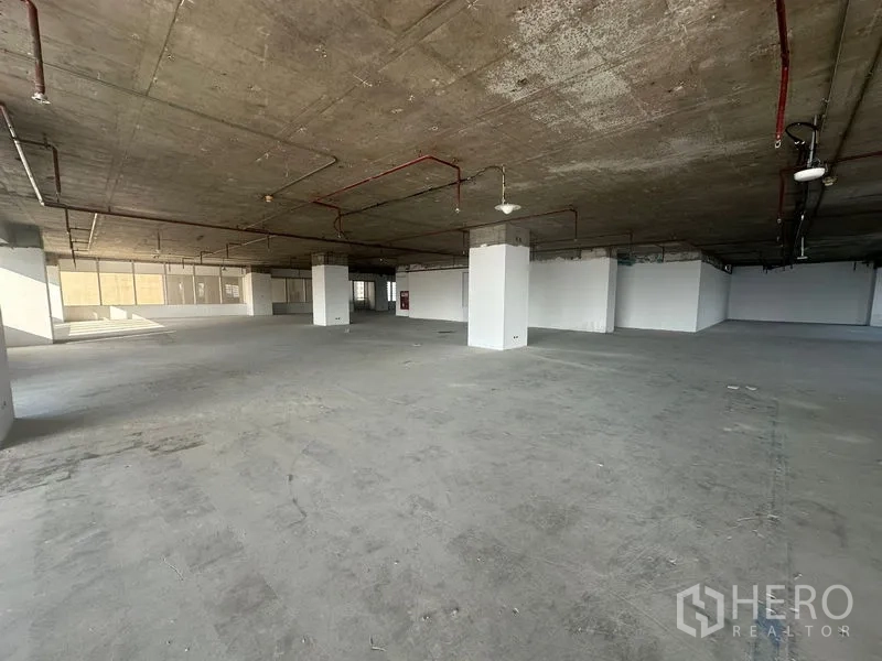 Office Space for rent in Watthana, Bangkok - Expansive shell-and-core office floor plate with structural columns and visible ceiling services.