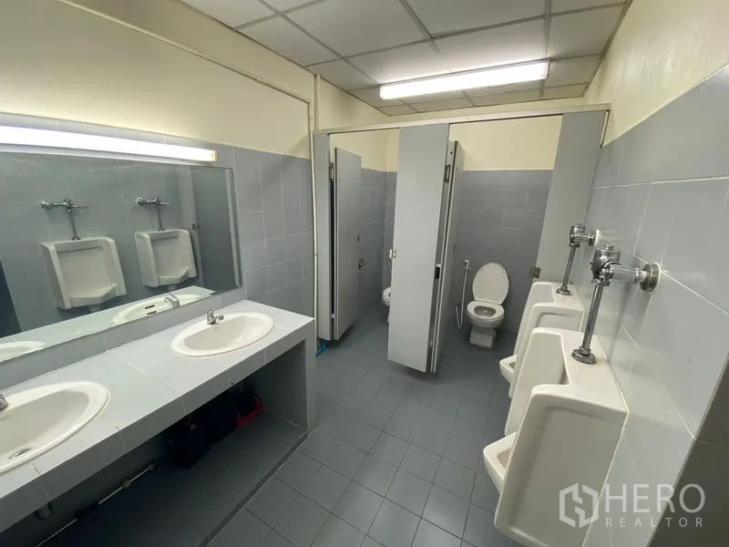 Office Space for rent in Huai Khwang, Bangkok - Shared restroom with double sinks, mirrors, urinals and private stalls.