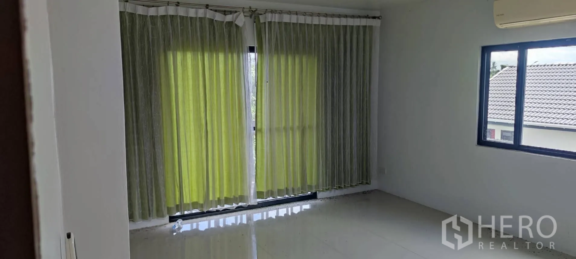 Warehouse for sale in Thung Khru, Bangkok - Bedroom or office with green curtains and window air-conditioner.