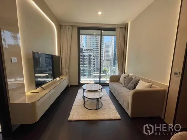 คอนโด ให้เช่า - มุมนั่งเล่นร่วมสมัยมีโต๊ะกลางซ้อนและประตูกระจกสูงจรดเพดาน