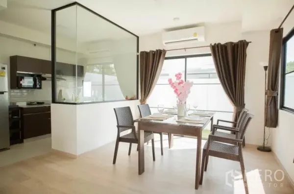 Townhouse for rent in Bang Phli, Samut Prakan - Bright dining area beside a glass-partitioned kitchen with large windows.