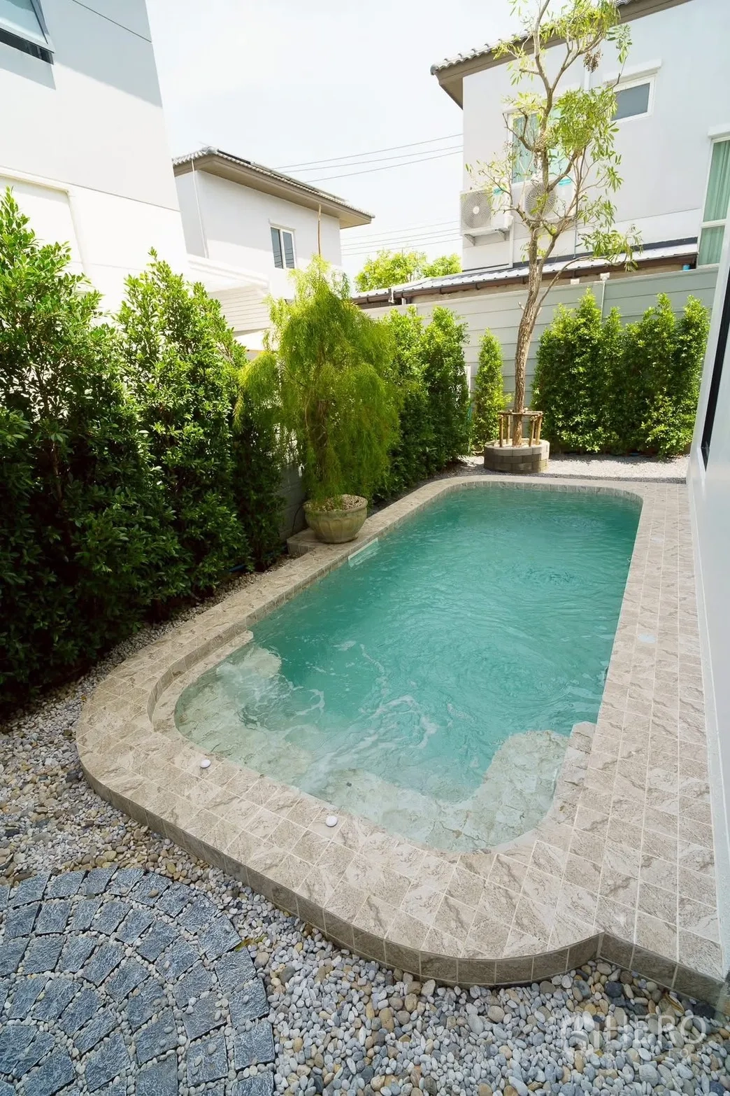 Detached House for sale in Bang Phli, Samut Prakan - Compact private swimming pool in a walled courtyard framed by greenery