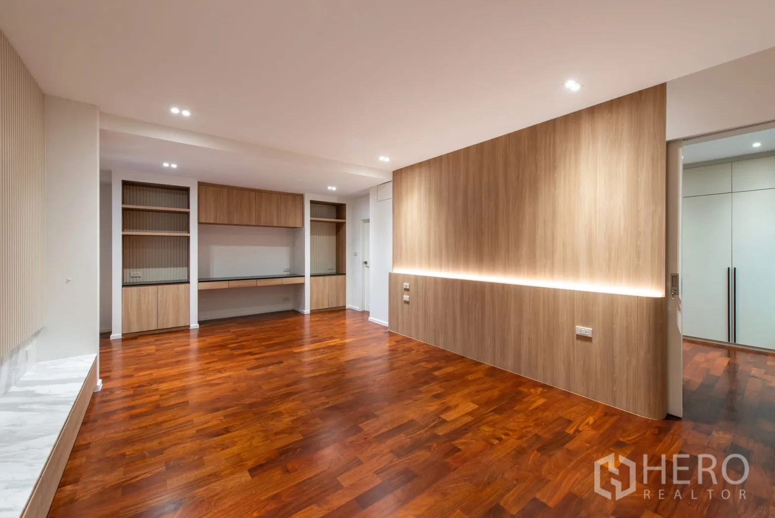 Detached House for sale in Bang Phli, Samut Prakan - Family lounge with wood feature wall, LED accent lighting and wooden floors.