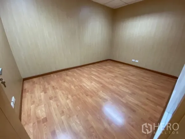 Office Space for rent in Watthana, Bangkok - Compact private office with wood floors and paneled walls.