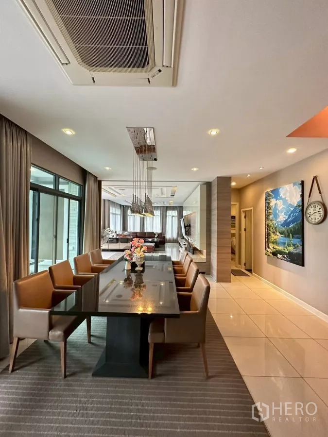 Detached House for sale in Bang Lamung, Chon Buri - Dining area looking toward the living room with ceiling lighting and large windows.