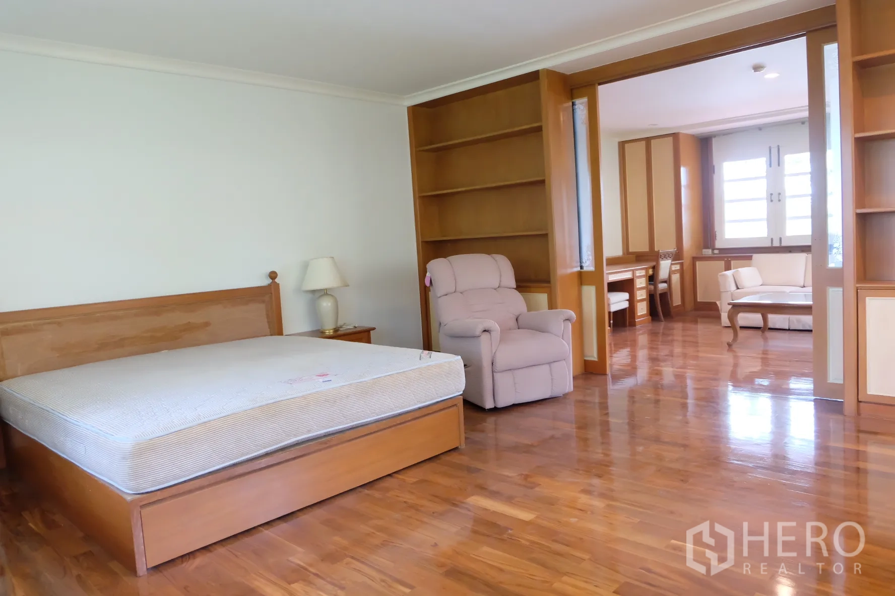 独立式住宅 出租在Bang Phli, Samut Prakan - 主卧木地板，大床与躺椅，推拉门连通书房。