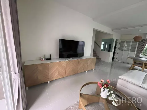 Detached House for rent in Bang Phli, Samut Prakan - Media console and staircase beside the dining zone in an airy ground floor.
