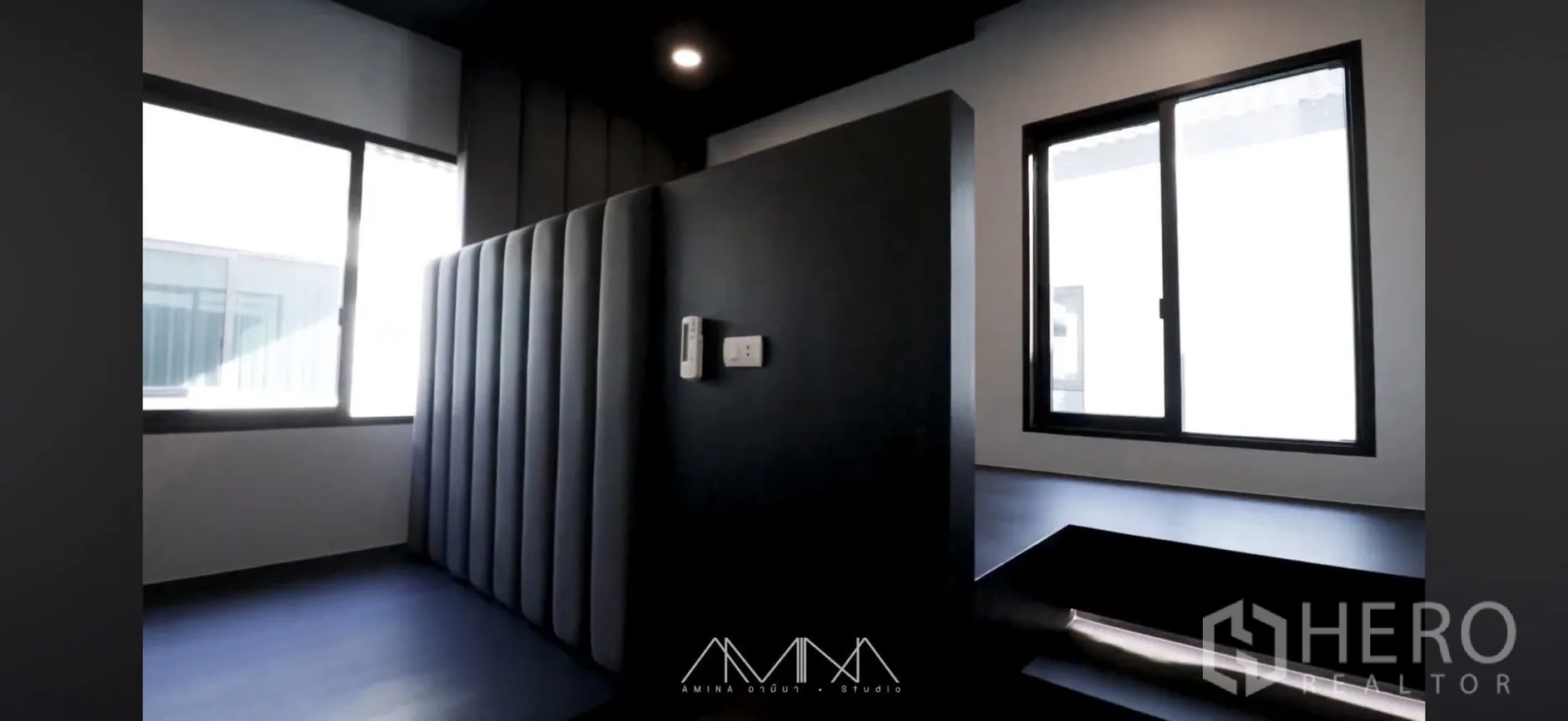 Detached House for rent in Saphan Sung, Bangkok - Dark-toned room with padded partition, large windows, and platform seating with LED strip lighting.