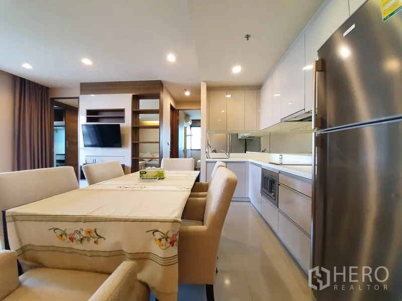 公寓 出租在Bang Rak, Bangkok - 明亮的内置厨房，带不锈钢冰箱与餐区，顶置筒灯照明