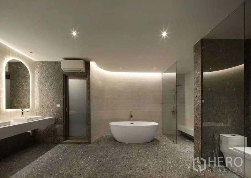 Home Office for sale in Chatuchak, Bangkok - Spa‑style bathroom with central tub, glass shower enclosure and terrazzo finishes.