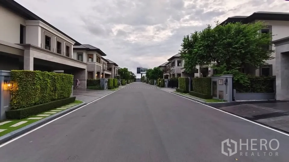 Detached House for rent or sale in Lat Krabang, Bangkok - Tree-lined private street of modern two-storey houses within a gated community.