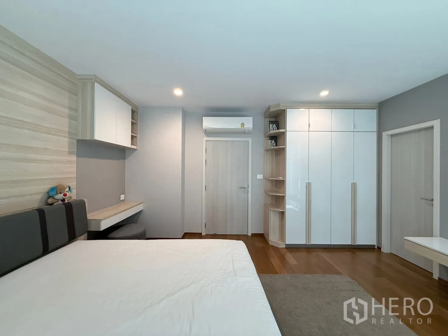 Townhouse for rent in Saphan Sung, Bangkok - Bedroom with upholstered headboard, wardrobes and workspace.