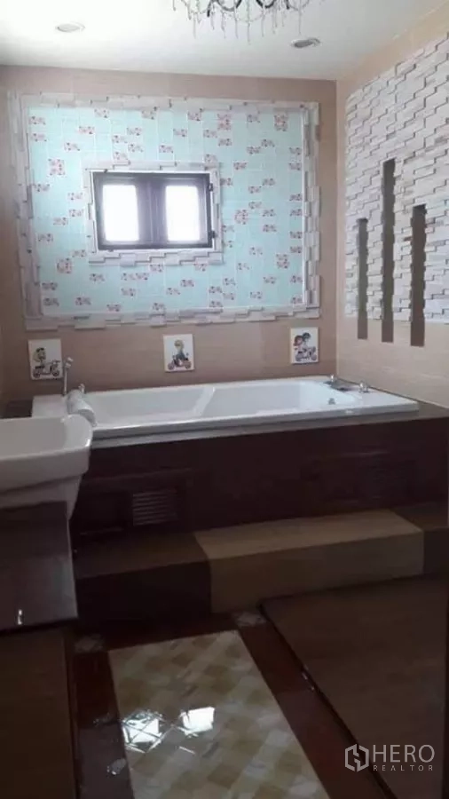Detached House for sale in Bueng Kum, Bangkok - Bathroom with large soaking bathtub and decorative wall tiles.