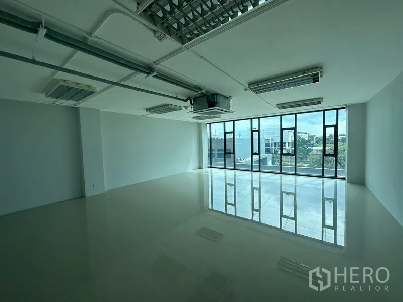 สำนักงาน ให้เช่าในBang Phli, Samut Prakan - สำนักงานโล่งสว่าง 65 ตร.ม. กระจกเต็มผนัง พื้นกระเบื้องเงา ไฟแขวน และระบบแอร์ท่อลม มองเห็นวิวพื้นที่สีเขียว