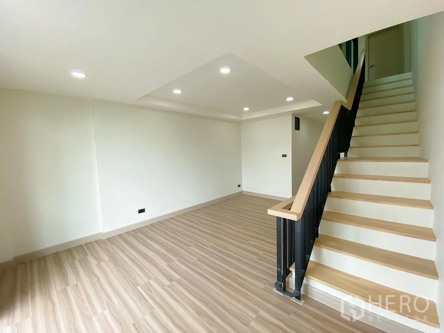 Home Office for rent or sale in Phra Khanong, Bangkok - Open-plan living or workspace with staircase and wood handrail.