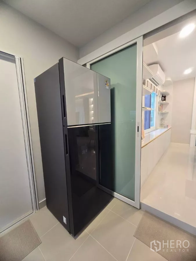 Detached House for rent in Bang Phli, Samut Prakan - Tall refrigerator next to sliding glass door leading to the dining area.