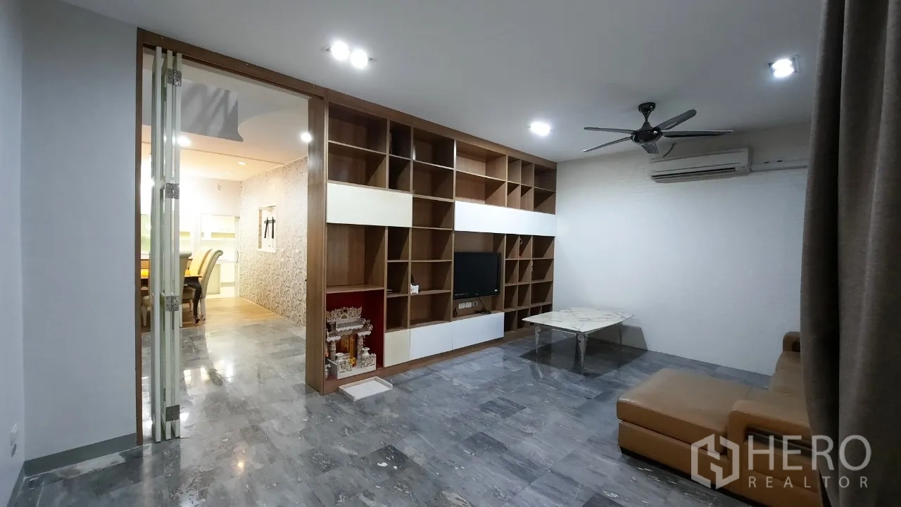 Townhouse for sale in Suan Luang, Bangkok - Living room with large built-in shelving and marble-look floor