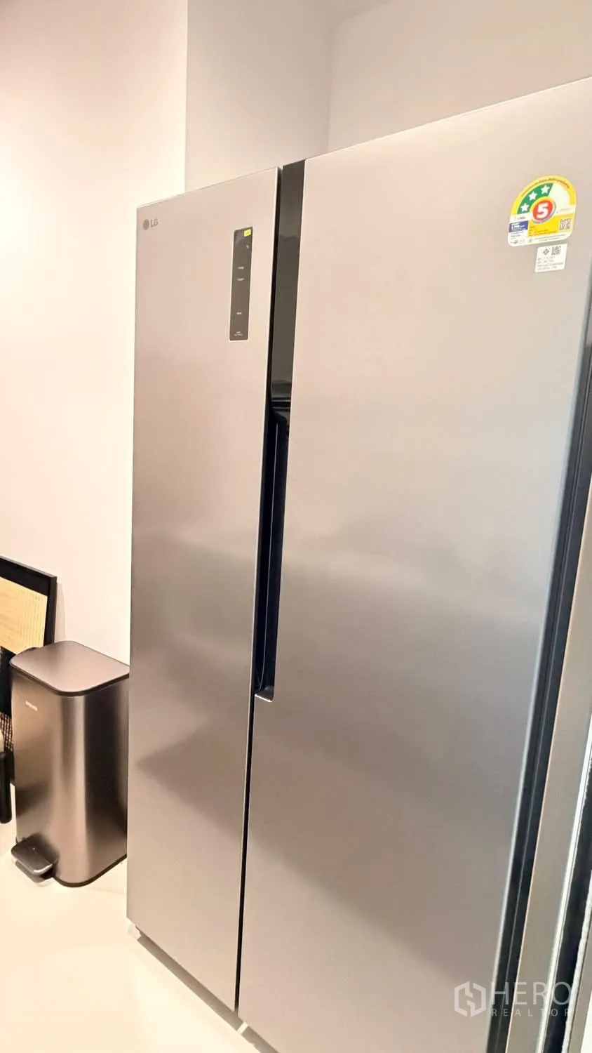 Condominium for rent in Watthana, Bangkok - Stainless side-by-side refrigerator in a modern kitchen corner.