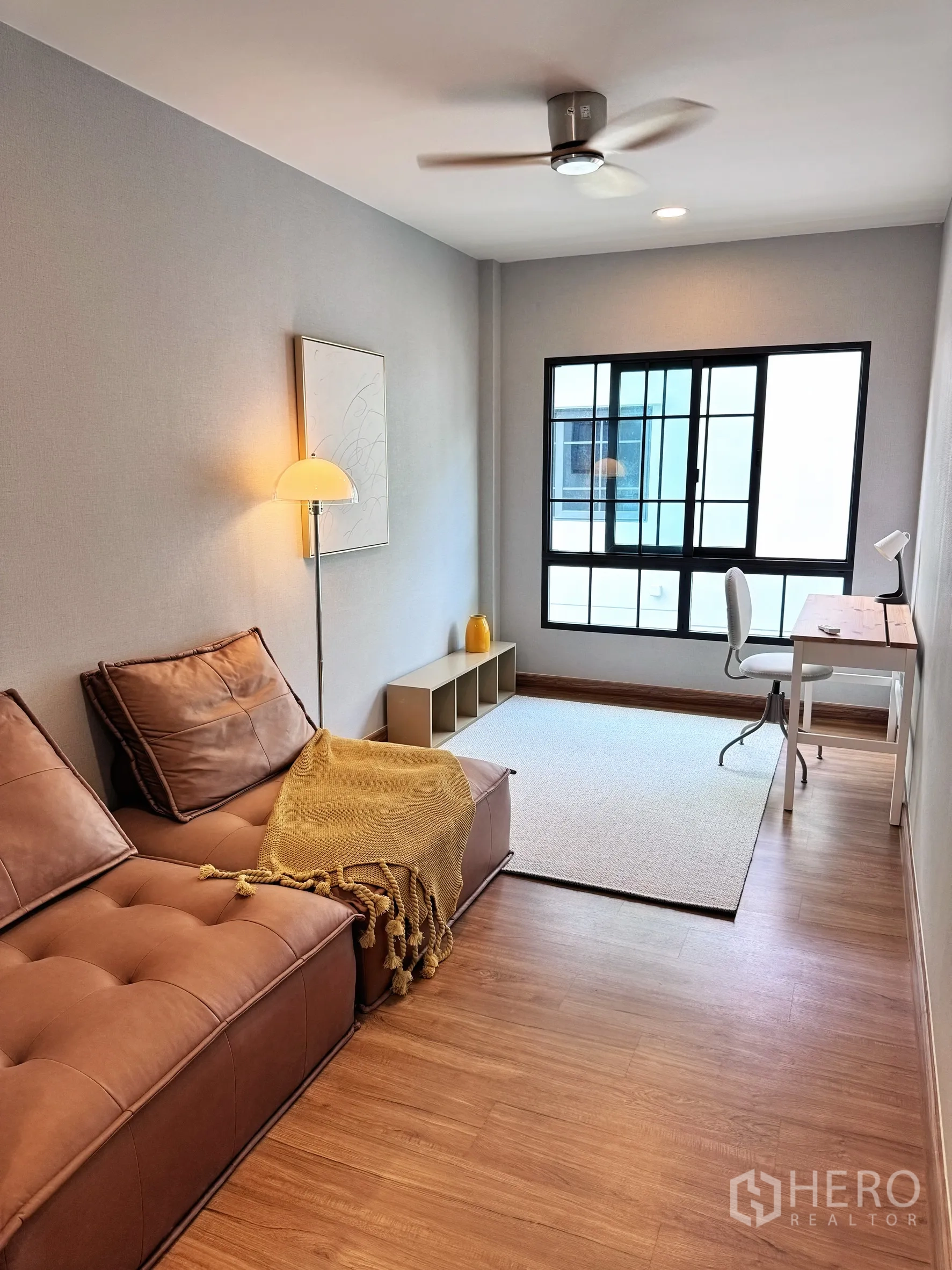 Detached House for rent in Bang Phli, Samut Prakan - Cozy study or den with sofa, floor lamp, ceiling fan, and desk by a large window.