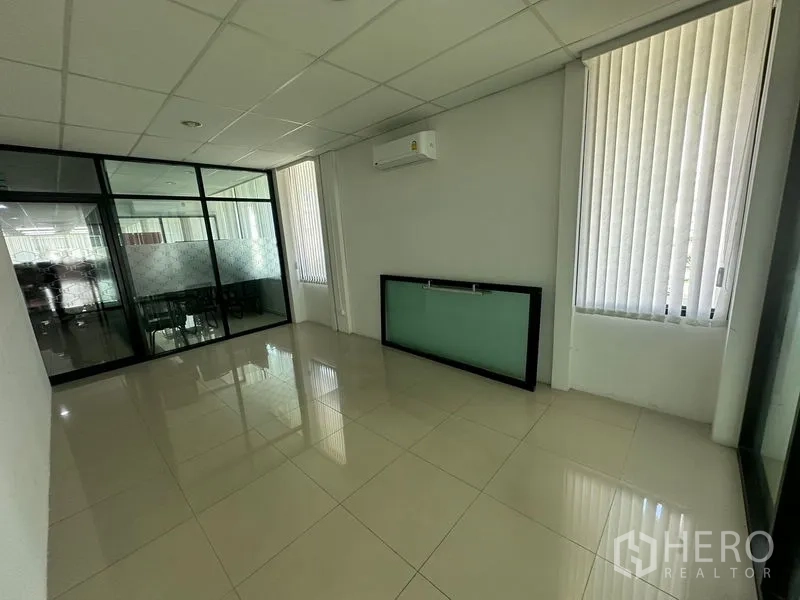 Office Space for rent - Compact private office with vertical blinds, glass partition and wall-mounted AC unit.