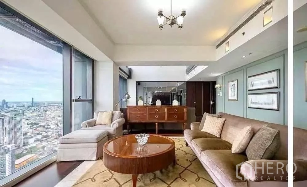 Condominium for rent in Sathon, Bangkok - Corner living space with sideboard, rug and wraparound city views from expansive windows.