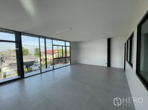 Warehouse for rent in Phra Samut Chedi, Samut Prakan - Corner office with full-height glass wall overlooking the neighborhood.