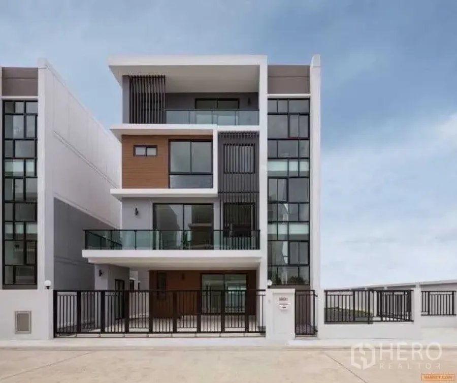 Home Office for rent or sale in Bang Phli, Samut Prakan - Front elevation of a new home office showing large windows, black metal fence and wide driveway.
