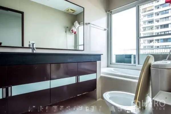 คอนโด ให้เช่าหรือขายในWatthana, Bangkok - ห้องน้ำสว่าง อ่างล้างหน้ายาว อ่างอาบน้ำริมหน้าต่าง และโถสุขภัณฑ์