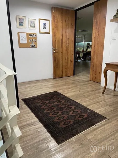 Office Space for rent in Khlong Toei, Bangkok - Upper landing with wooden doors, framed art and light wood flooring.
