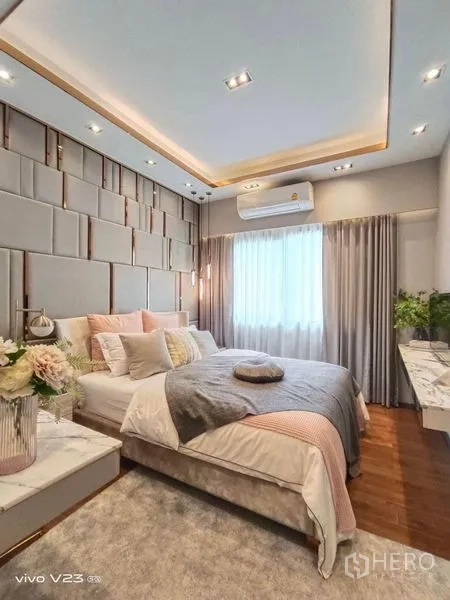 Detached House for sale in Wang Thonglang, Bangkok - Stylish guest bedroom with padded feature wall, soft lighting and window with curtains.