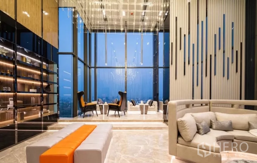 Condominium for rent in Chatuchak, Bangkok - Sky lounge with double‑height ceiling, chandeliers and city views.