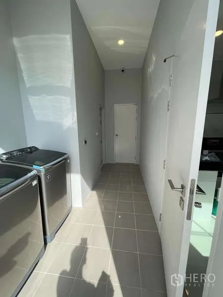 Detached House for sale in Thawi Watthana, Bangkok - Utility corridor with twin washing machines and storage access