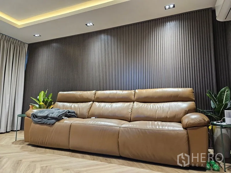 Detached House for sale in Thawi Watthana, Bangkok - Lounge wall with fluted panels and a tan leather sofa.