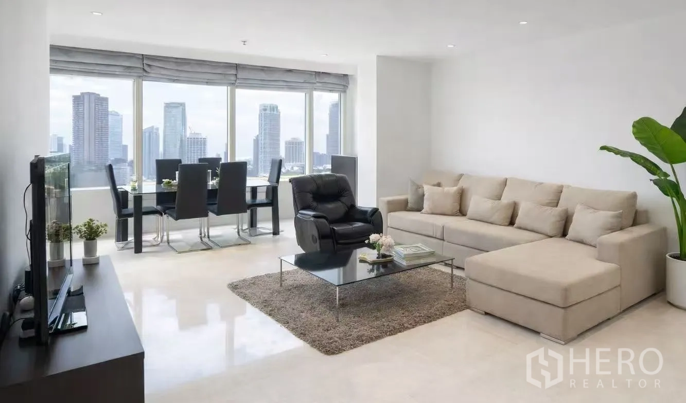Condominium for rent in Watthana, Bangkok - Bright living and dining area with floor-to-ceiling windows and skyline backdrop.