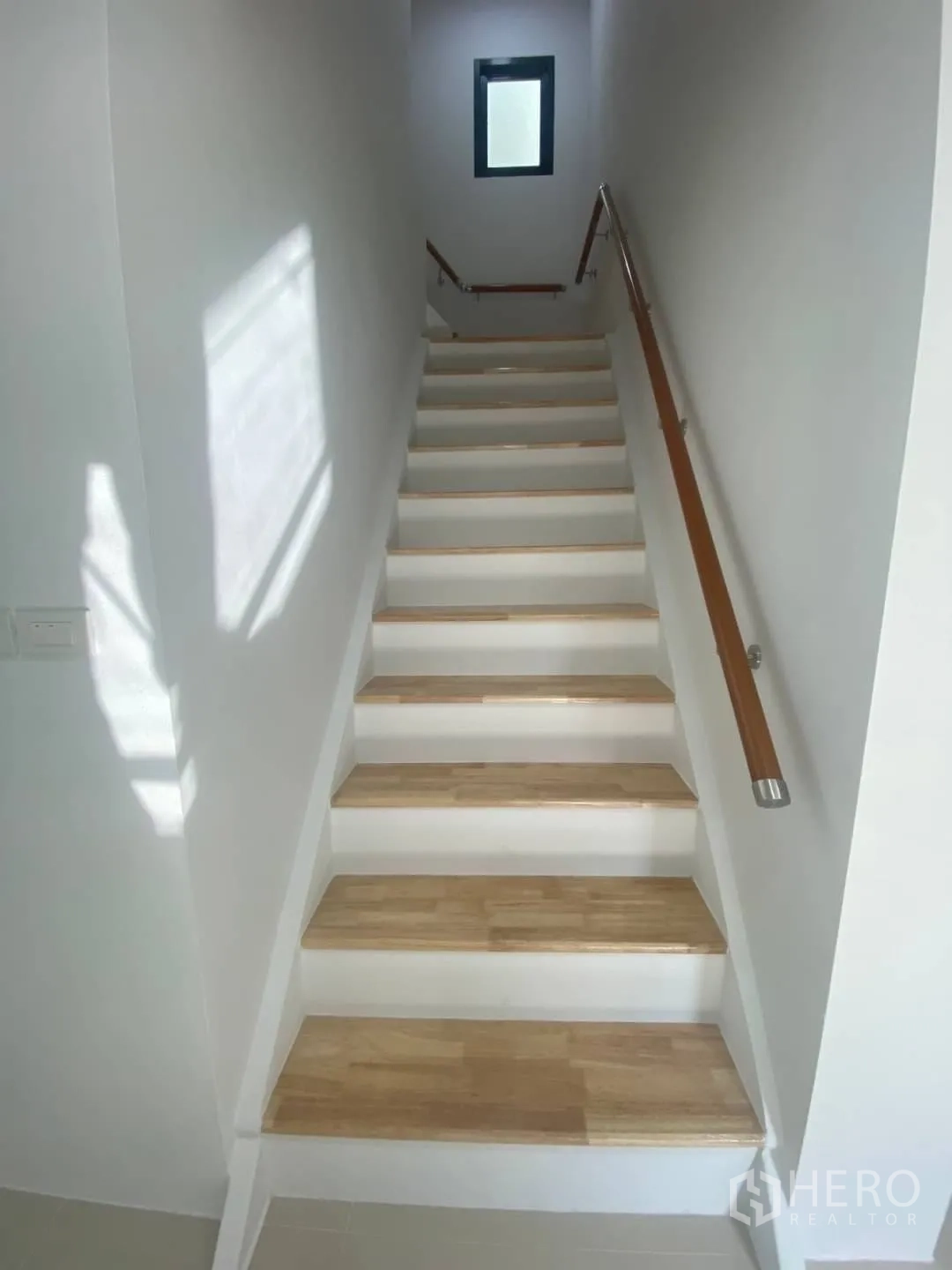Home Office for sale - Staircase ascending to upper floors with wooden treads and handrails.