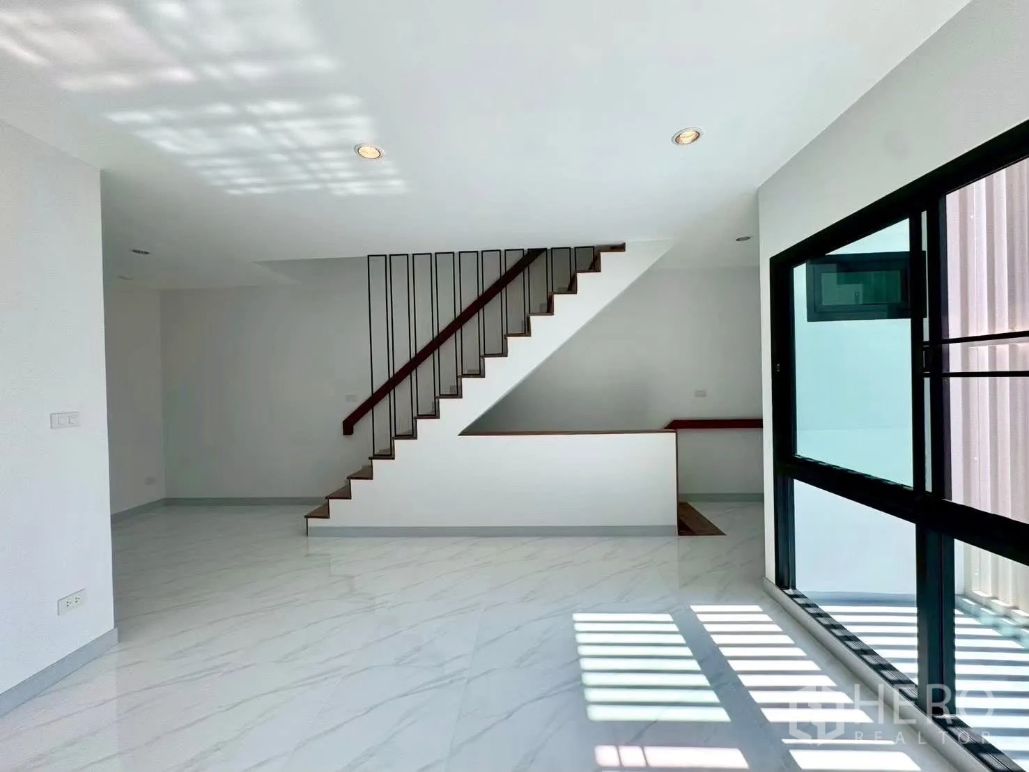 Home Office for rent in Wang Thonglang, Bangkok - Open room with staircase feature and full-height windows by balcony.