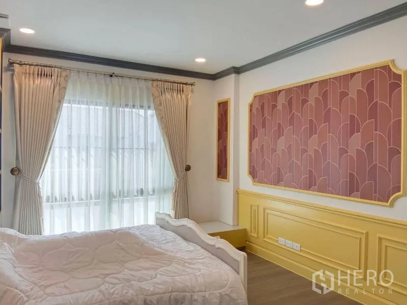 Detached House for rent or sale in Saphan Sung, Bangkok - Bedroom with pink and yellow paneling and sheer window drapes.