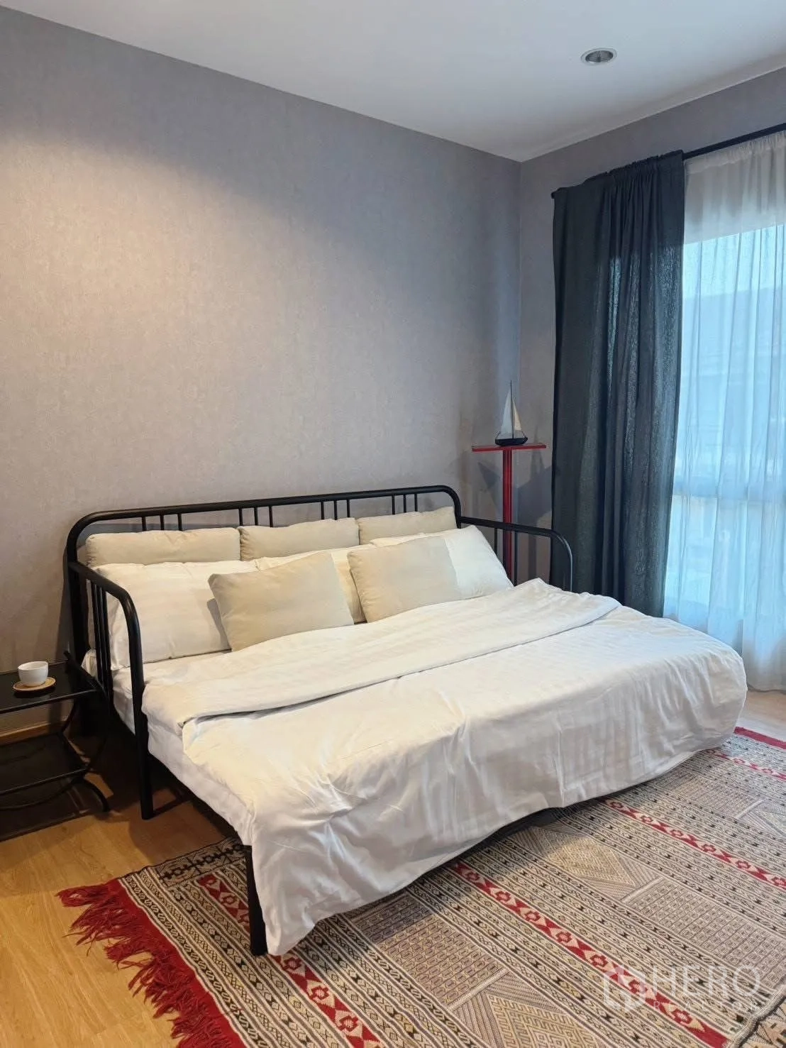 Detached House for rent or sale in Suan Luang, Bangkok - Daybed with white linens on patterned rug beside window.