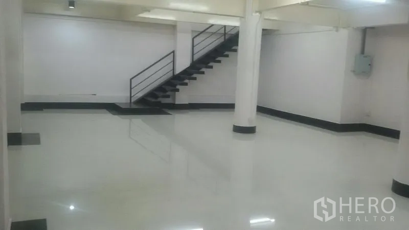 Office Space for rent in Sathon, Bangkok - Open office zone with white columns and a metal staircase leading to an upper area.