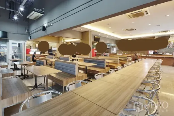 Office Space for rent in Bang Na, Bangkok - On-site building canteen with long communal tables, booth seating and modern lighting.