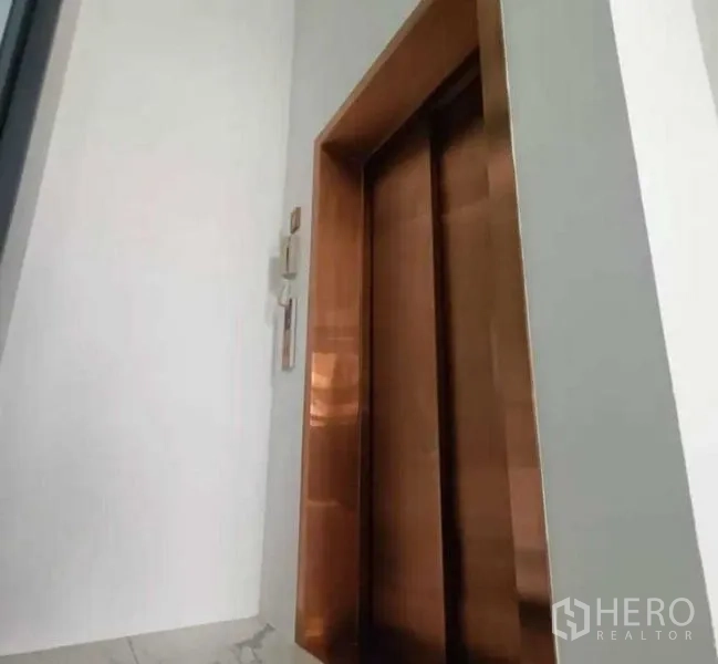 Home Office for rent in Suan Luang, Bangkok - Close-up of a private residential lift with bronze-colored doors.