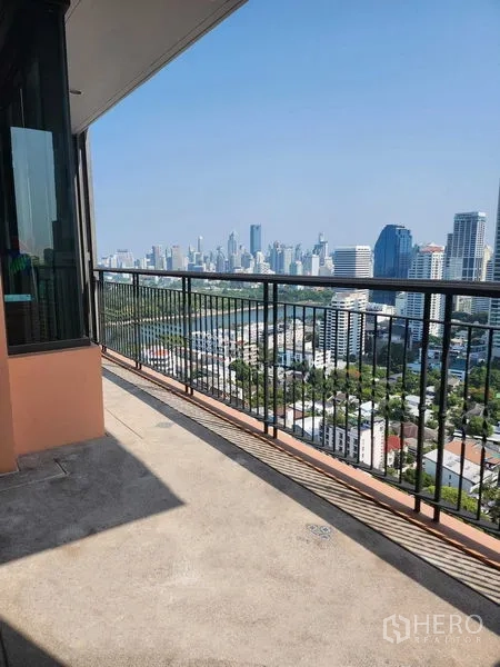 Condominium for sale in Khlong Toei, Bangkok - High-floor balcony with metal railing and panoramic city view.