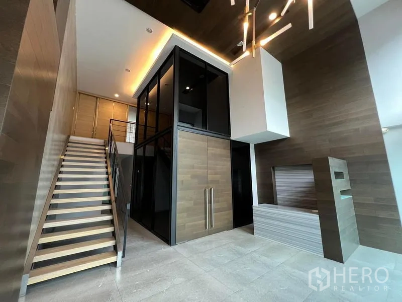 สำนักงานที่บ้าน ให้เช่าในBueng Kum, Bangkok - โถงต้อนรับเพดานสูงพร้อมโคมไฟดีไซน์ ผลงานไม้ และบันไดเด่น