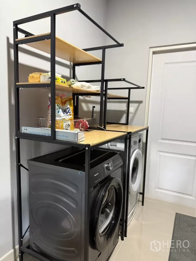 Detached House for rent in Bang Phli, Samut Prakan - Laundry zone with washing machine, dryer and metal storage shelving.