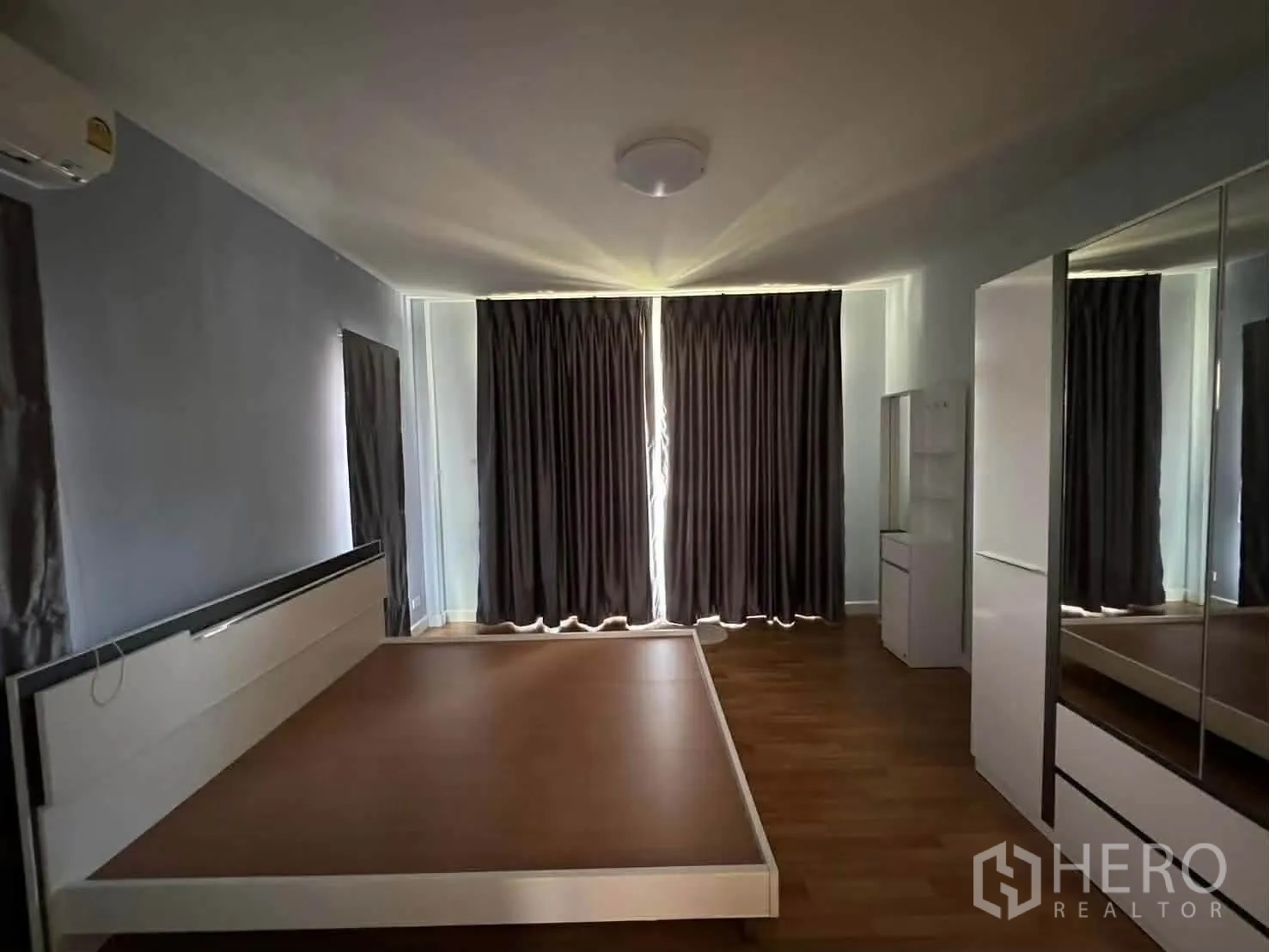 Detached House for rent in Watthana, Bangkok - Alternate view of the same bedroom with bed frame and mirrored wardrobe.