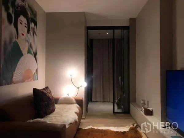 Condominium for rent in Watthana, Bangkok - Cozy living room with leather sofa, floor lamp, large artwork and a sliding glass door to the bedroom.