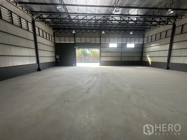 คลังสินค้า ให้เช่าในPrawet, Bangkok - มุมมองภายในแบบพื้นที่โล่งถึงประตูโหลดสินค้า พร้อมไฟไฮเบย์และช่องระบายอากาศ.