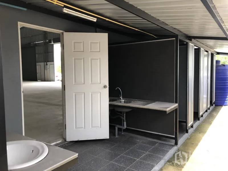 Warehouse for rent in Lat Lum Kaeo, Pathum Thani - External restroom block with sinks next to the warehouse entrance.