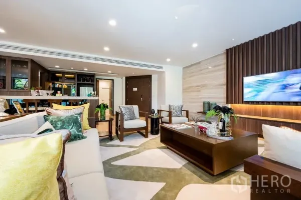 Condominium for sale - Bright lounge with TV feature wall, built-in cabinetry and breakfast bar leading to the kitchen.