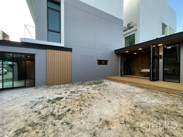 Townhouse for sale - Spacious rear yard with covered timber deck and sliding glass doors of a modern townhouse.